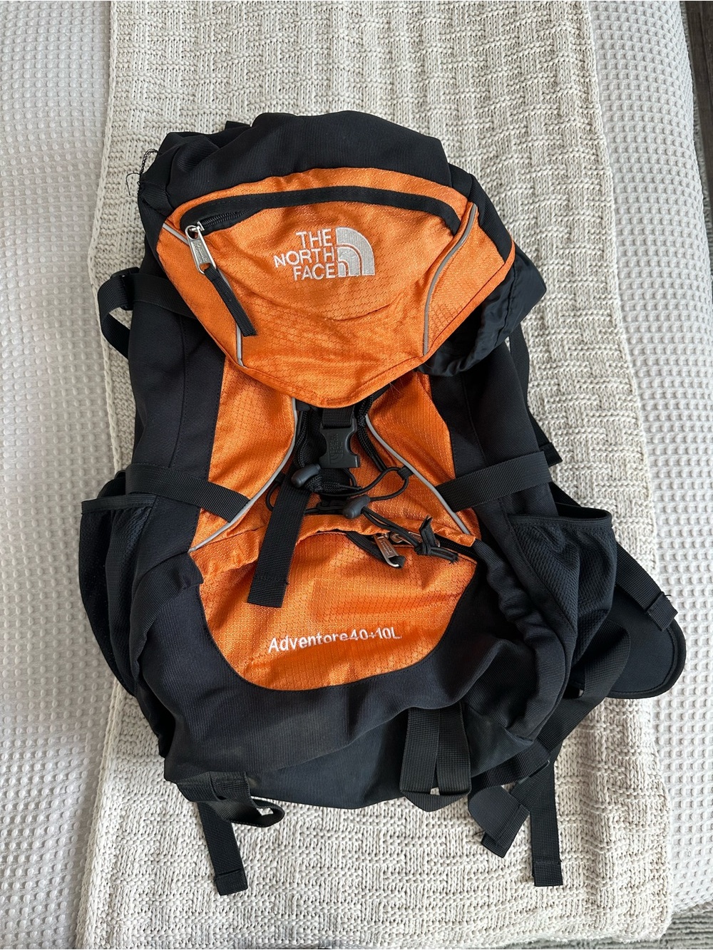 The North Face Orange and Black Adventure 40L Hiking Backpack